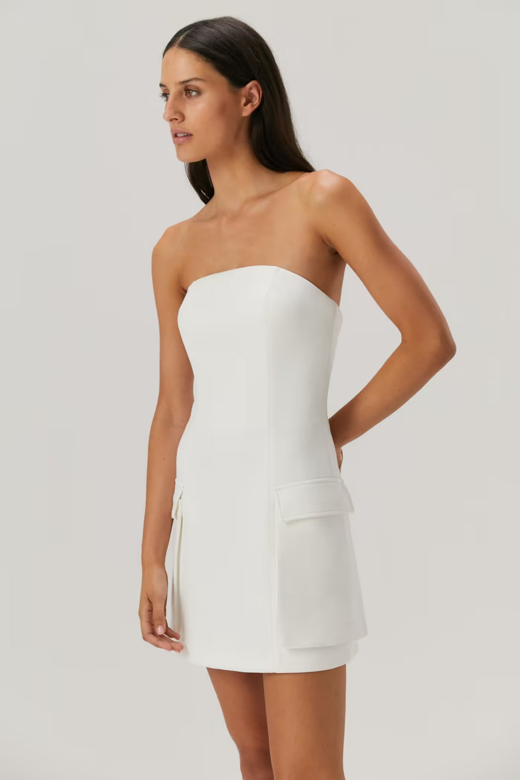 Ivory strapless mini dress with curved bust and patch pocket at the waist
