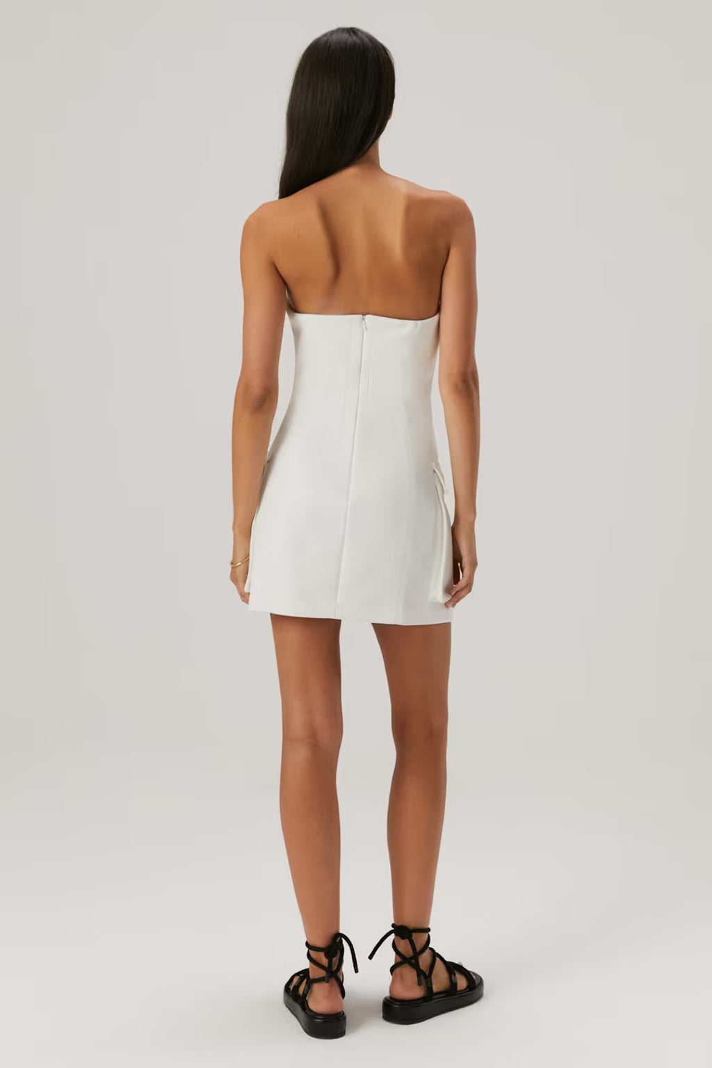 Ivory mini dress with open back, straight hem, and center seam