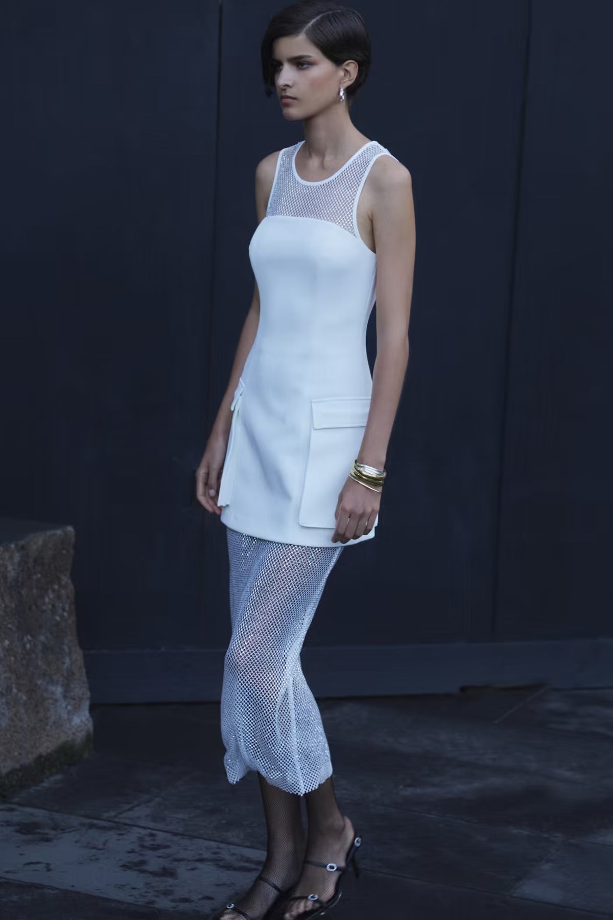 Ivory mini dress with wide straps, scoop neckline, and front pocket detail