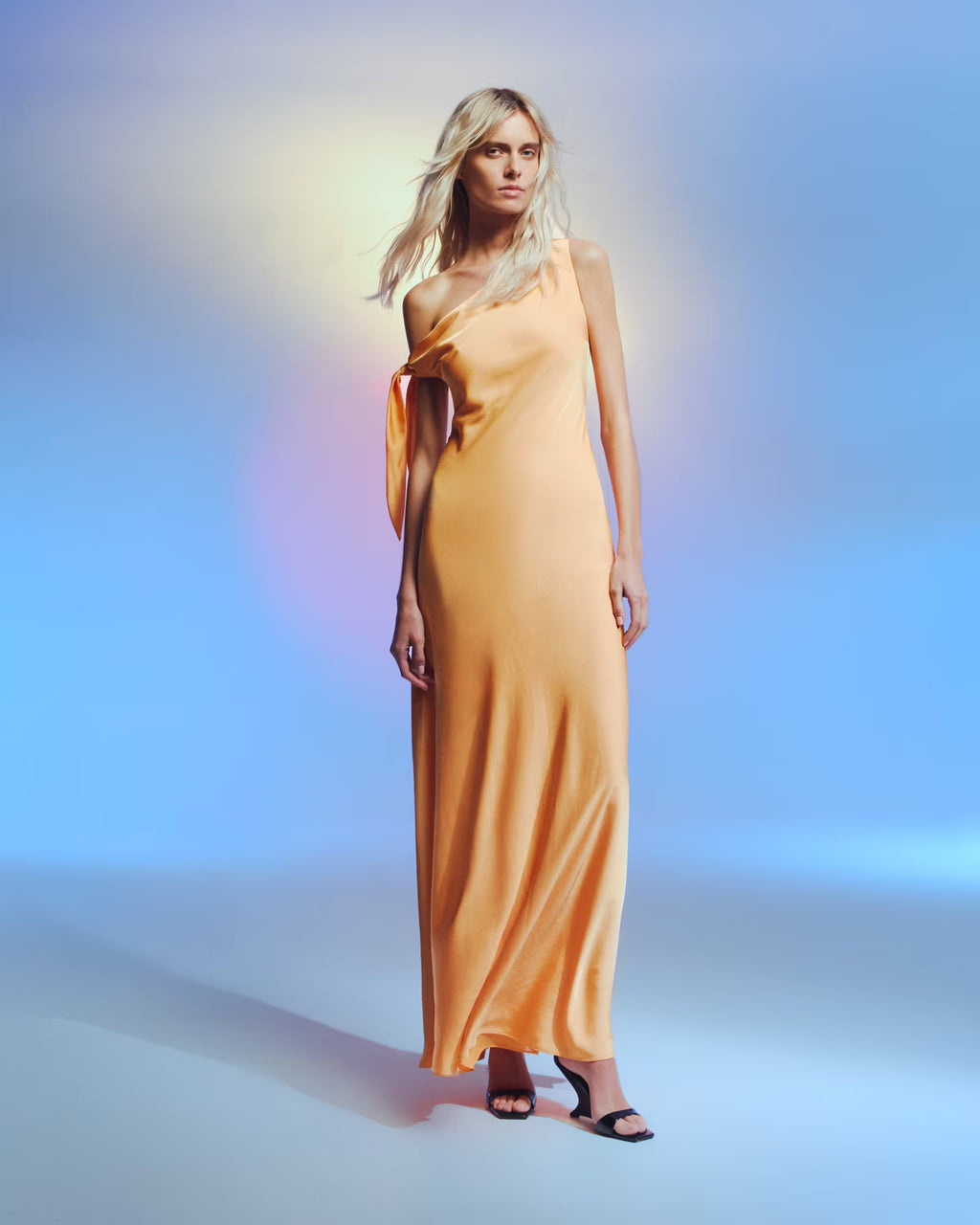 Tangerine satin one-shoulder maxi dress with tie strap and draped skirt