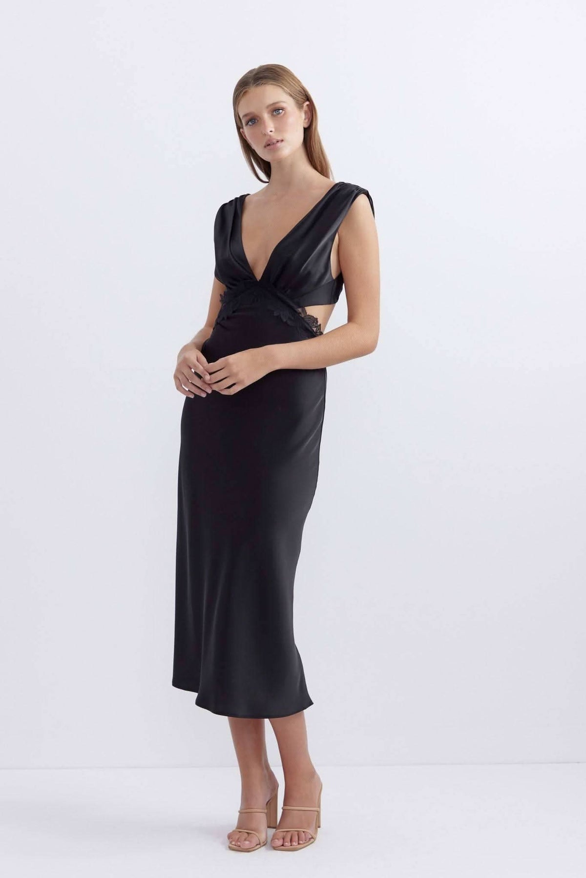 Black satin midi dress with deep V-neck, knot detail, and sleeveless silhouette.