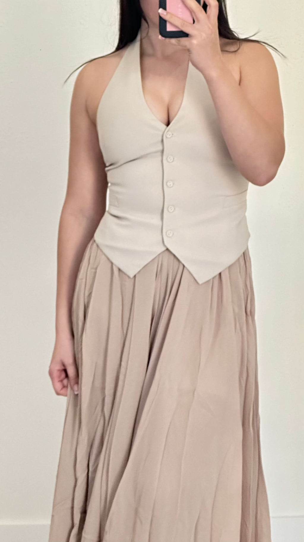 Stone sleeveless V-neck vest with button front and fitted, tailored silhouette.