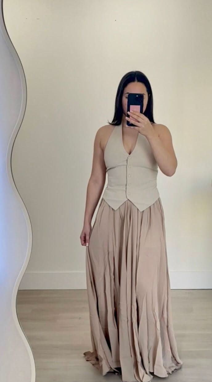 Stone Bridie vest with V-neckline and cropped peplum hem over a flowy skirt