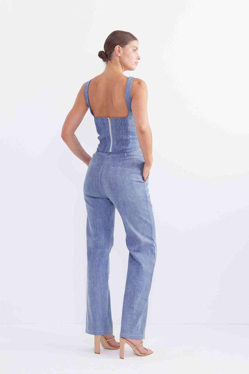 Sleeveless blue denim bodice with fitted back and seam panels