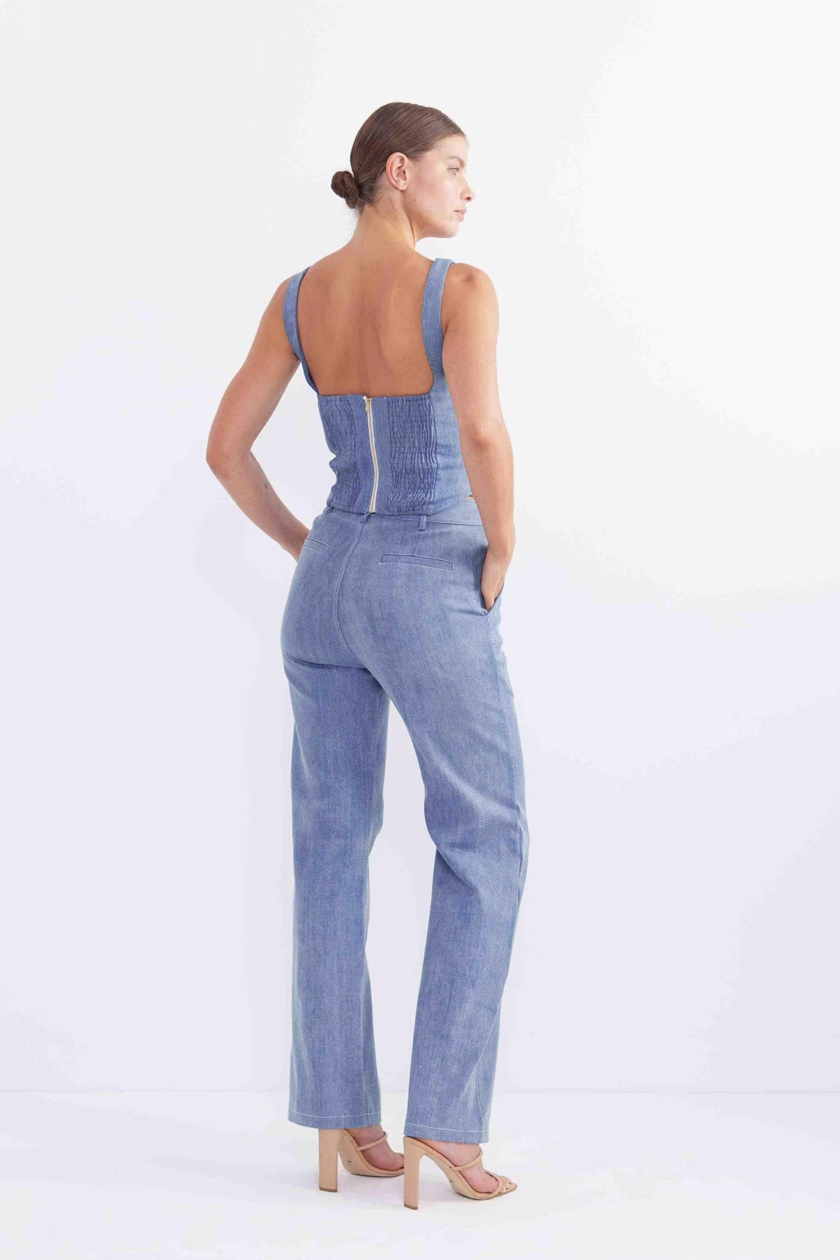 Sleeveless blue denim bodice with fitted back and seam panels