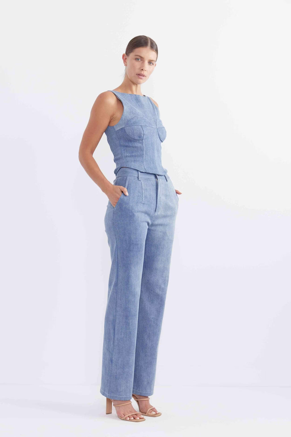 Sleeveless blue denim bodice with structured seams and peplum waist detail