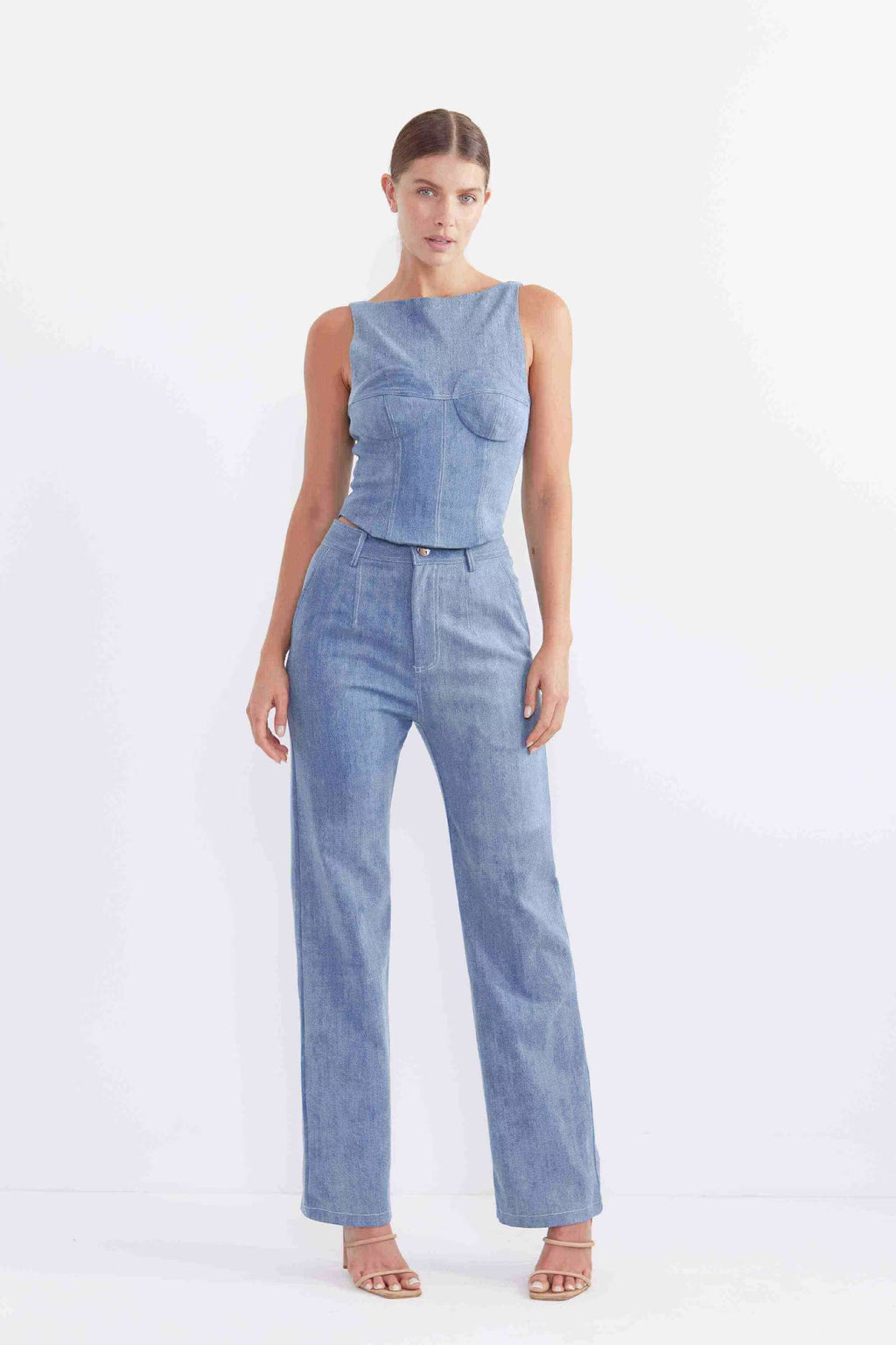 Sleeveless blue denim bodice with curved neckline and peplum waist