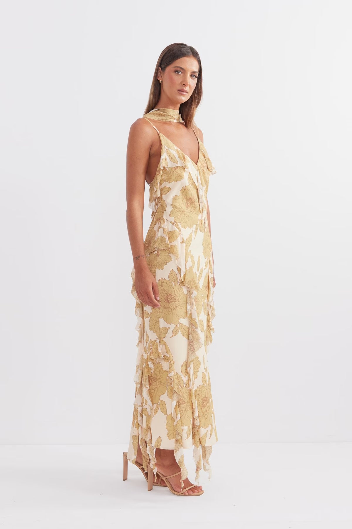 Golden midi slip dress with V-neck and soft ruffle tiers over floral print