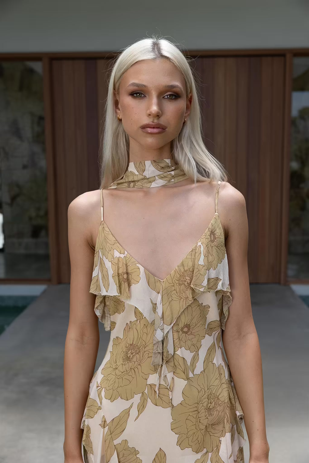 Golden floral midi dress with thin straps and V-neck bodice
