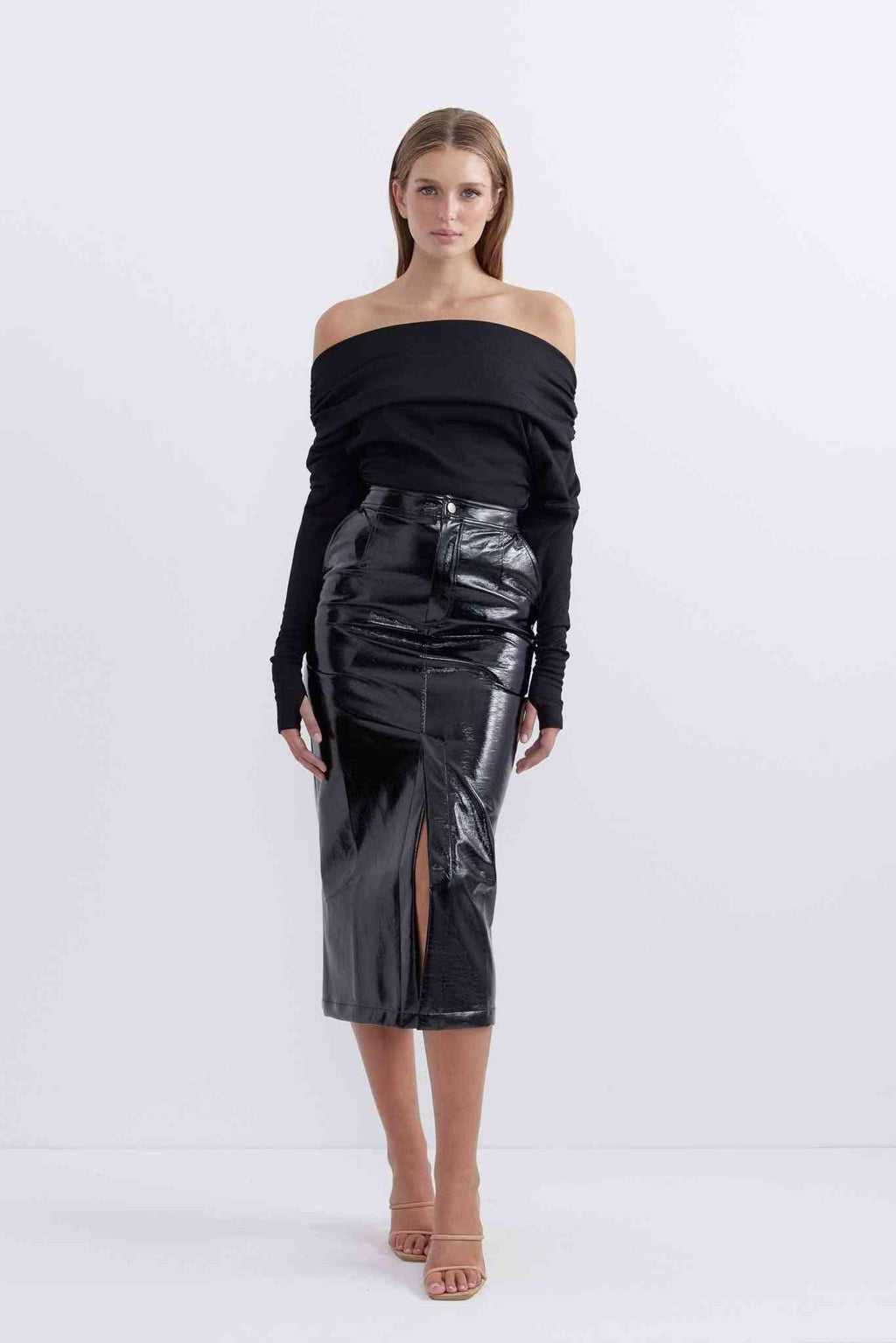 Patent black midi skirt with fitted waist and front slit, side view
