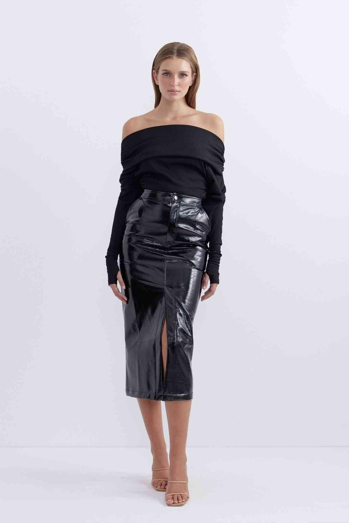 Patent black midi skirt with fitted waist and front slit, side view