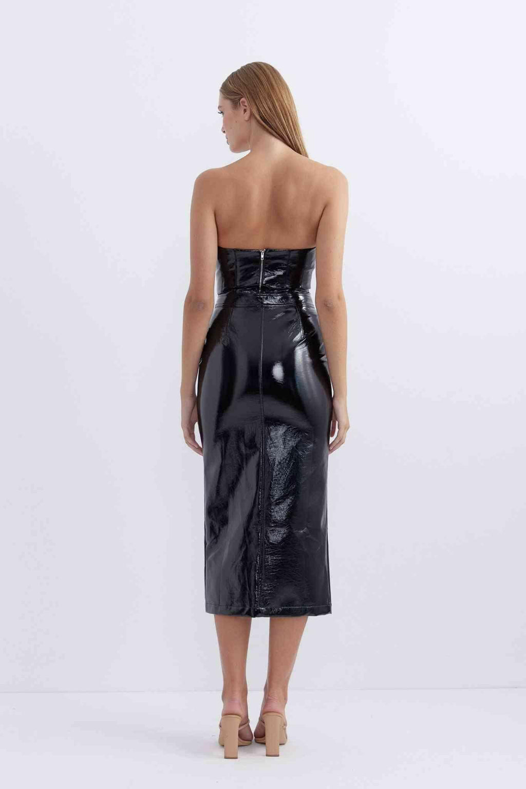 Glossy patent black midi skirt, back view, fitted waist and curved seam