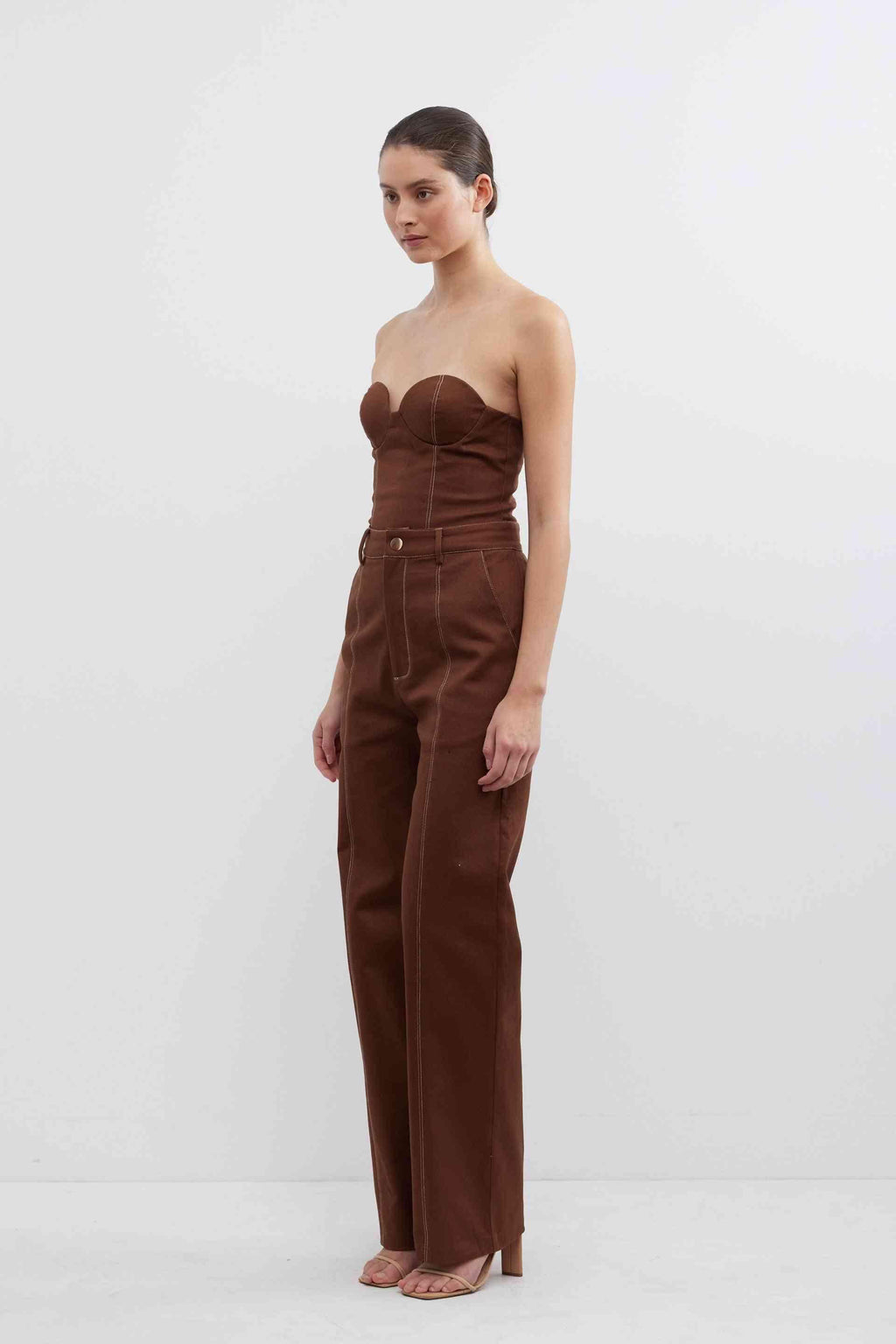 Fudge brown high-waist pants with strapless bodice, belt loops, and button-front closure
