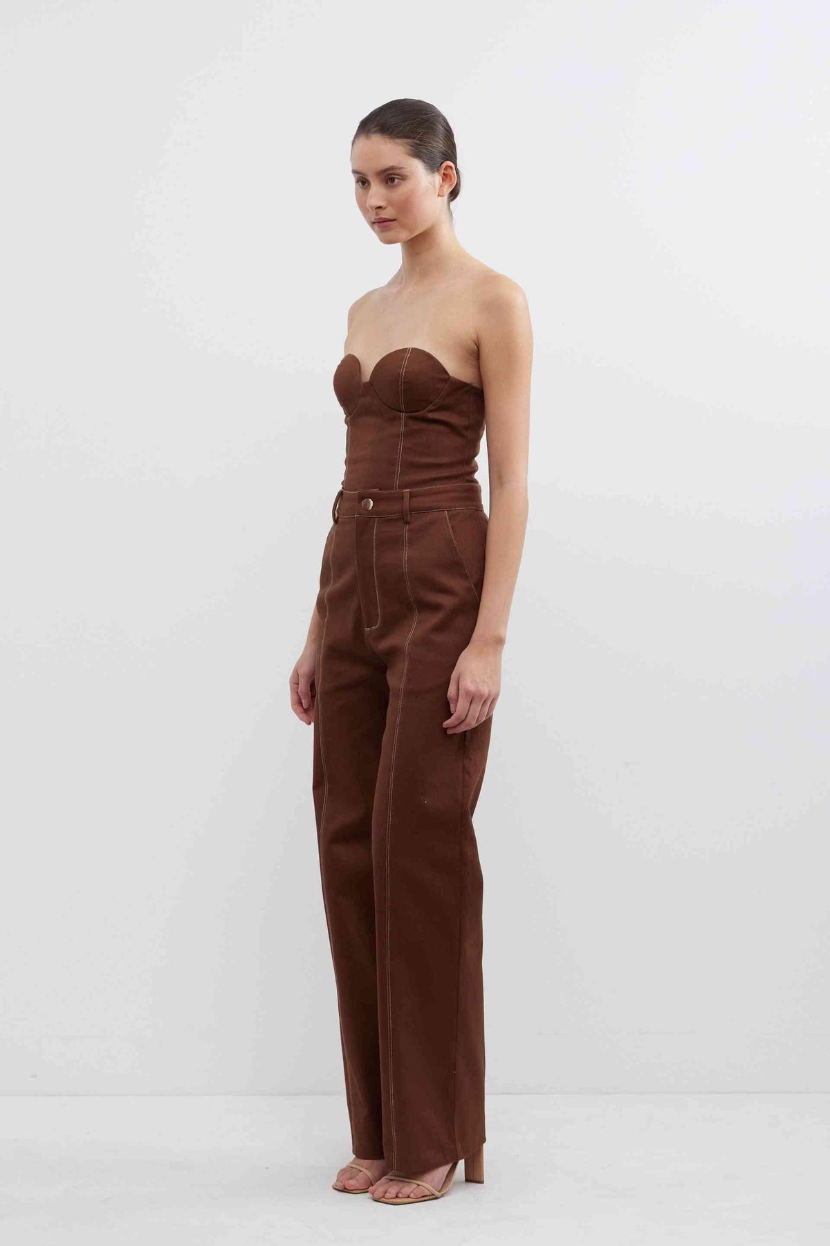 Fudge brown high-waist pants with strapless bodice, belt loops, and button-front closure