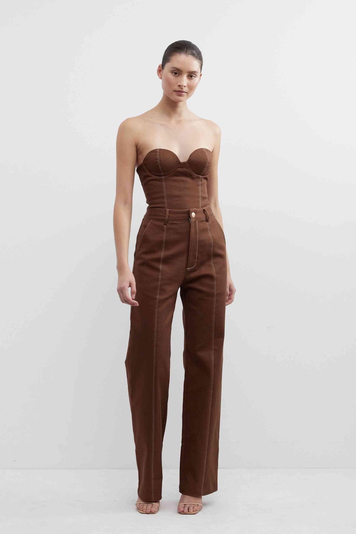 Fudge brown high-waist pants with strapless bodice, belt loops, and center button detail