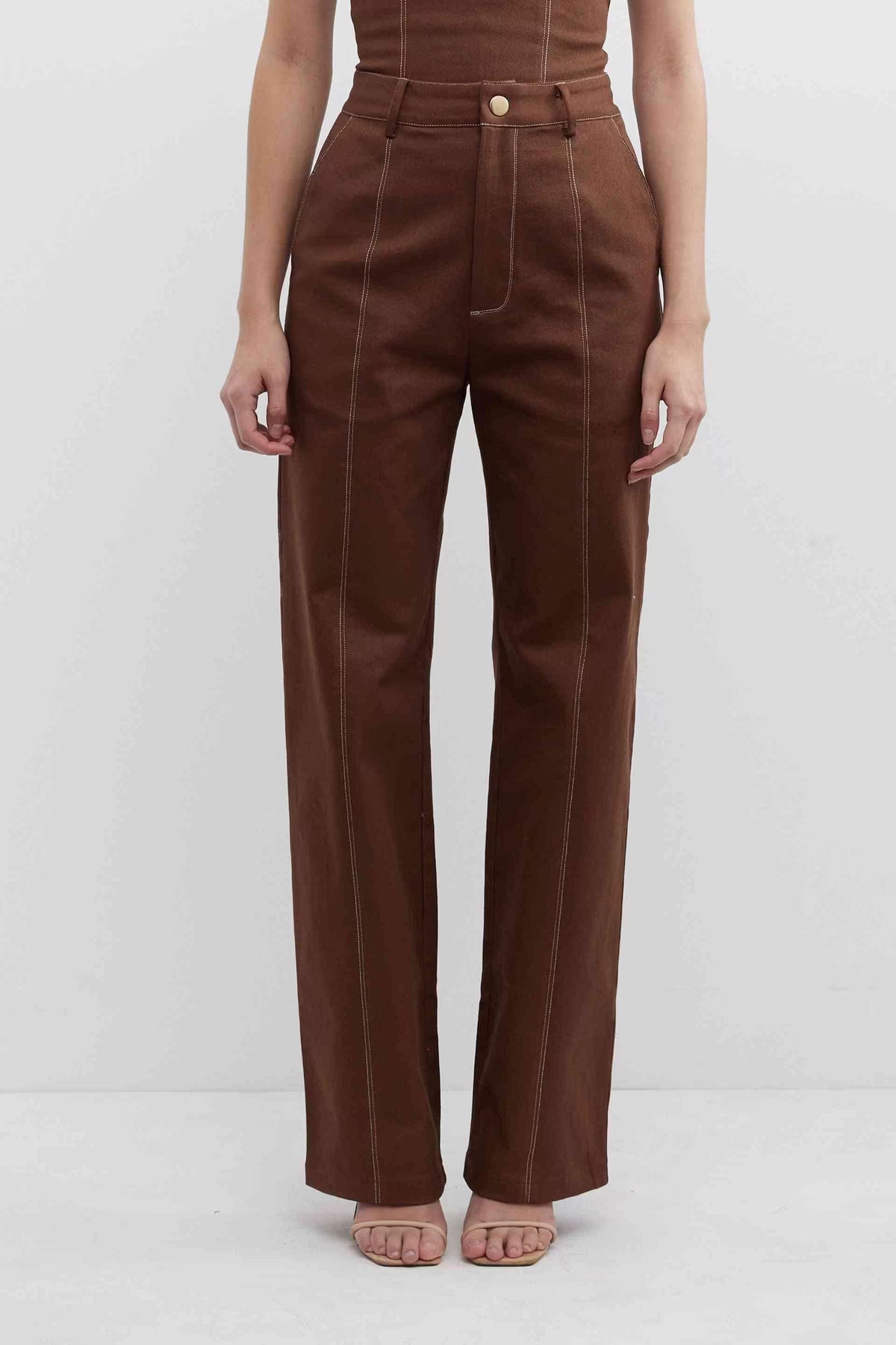 Fudge brown high-waist pants with belt loops, center button, and stitched vertical seams