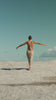 a person standing on top of a sandy beach