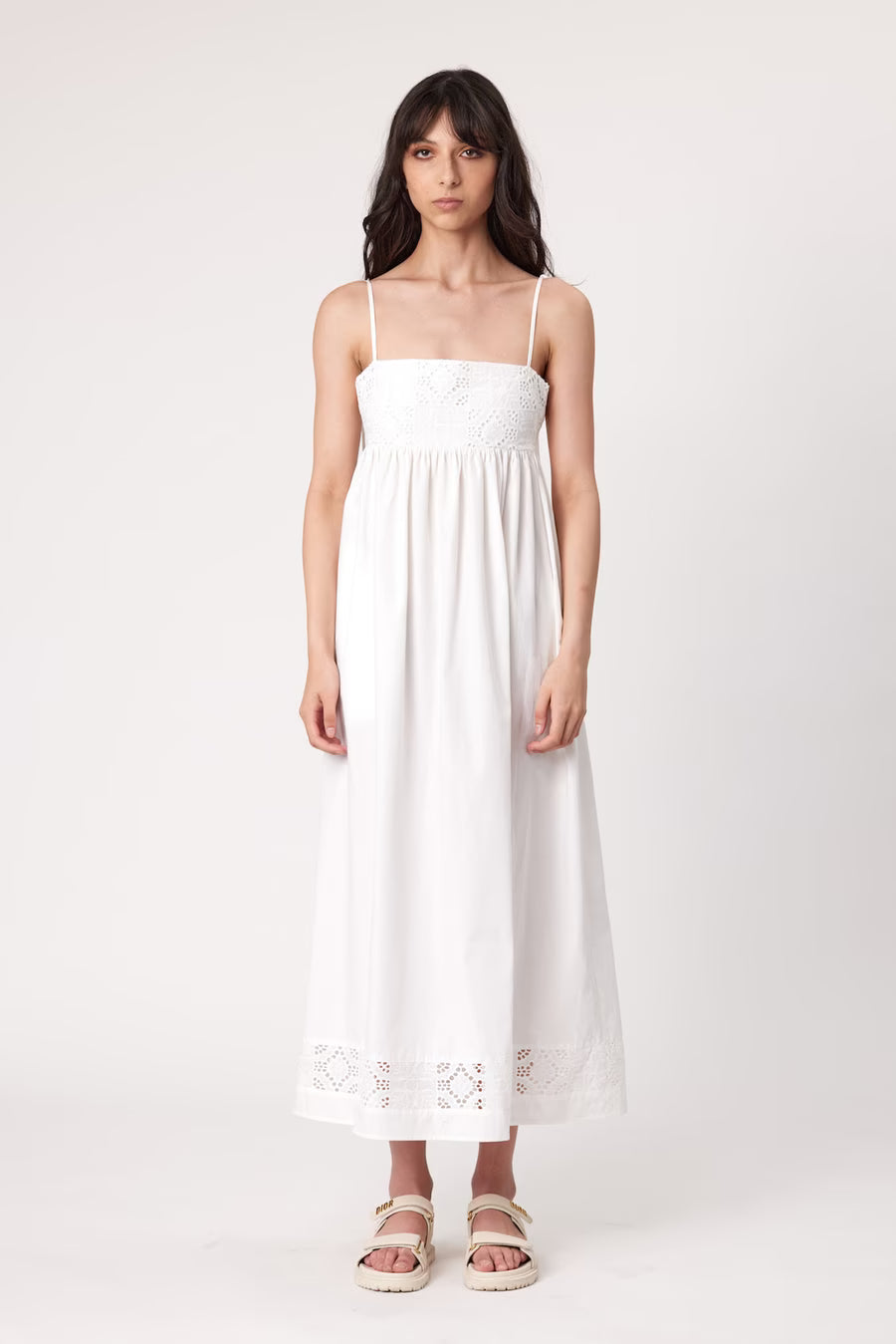 Ivory maxi dress with spaghetti straps, smocked bodice, and lace hem