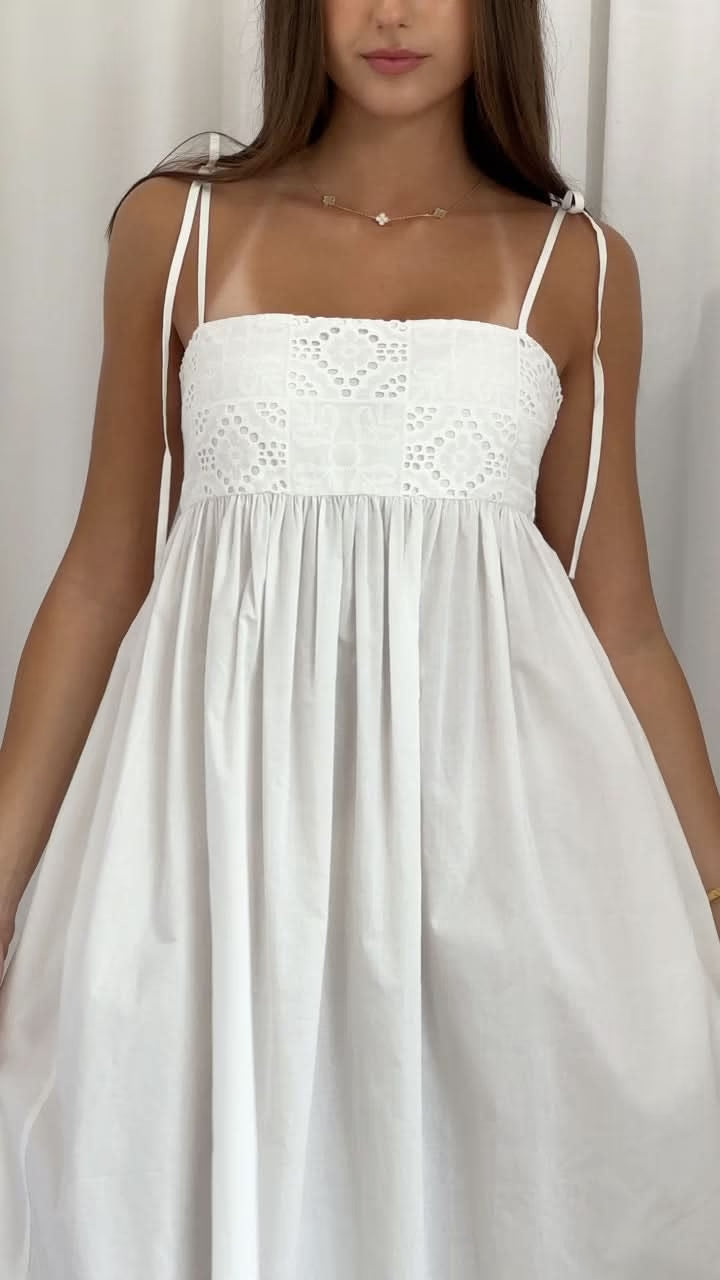 Ivory maxi dress close-up: lace bodice panel, smocked top, thin spaghetti straps