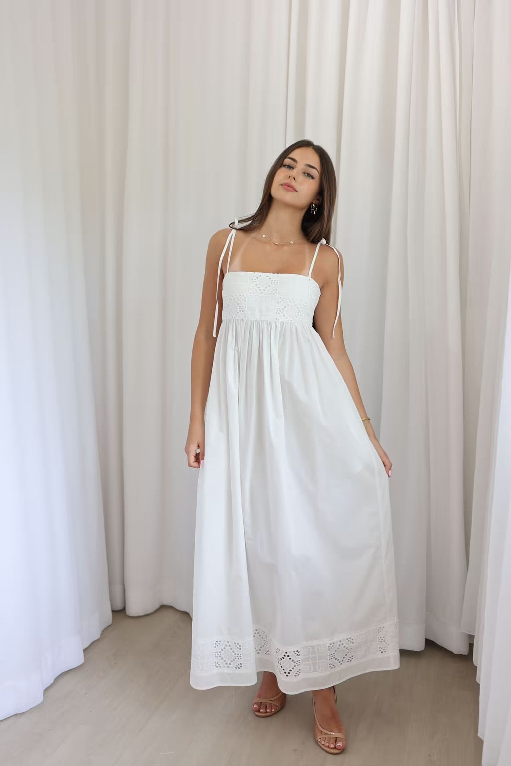 Ivory maxi dress front view with spaghetti straps and lace hem detailing