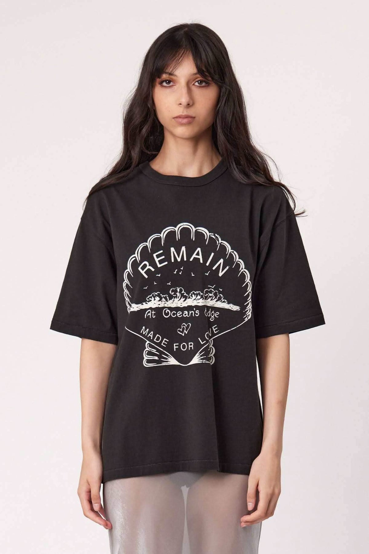 Washed black tee with large REMAIN-style chest graphic logo, crew neck