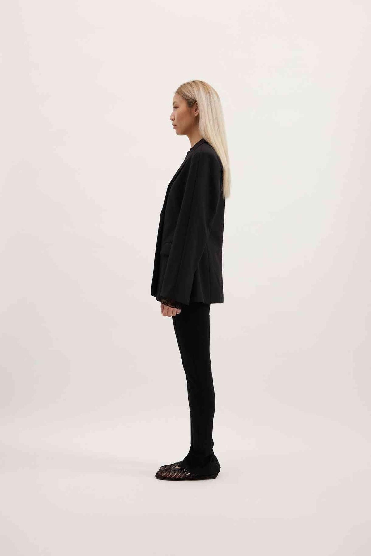 Black Sofia blazer side view with structured shoulders and long sleeves