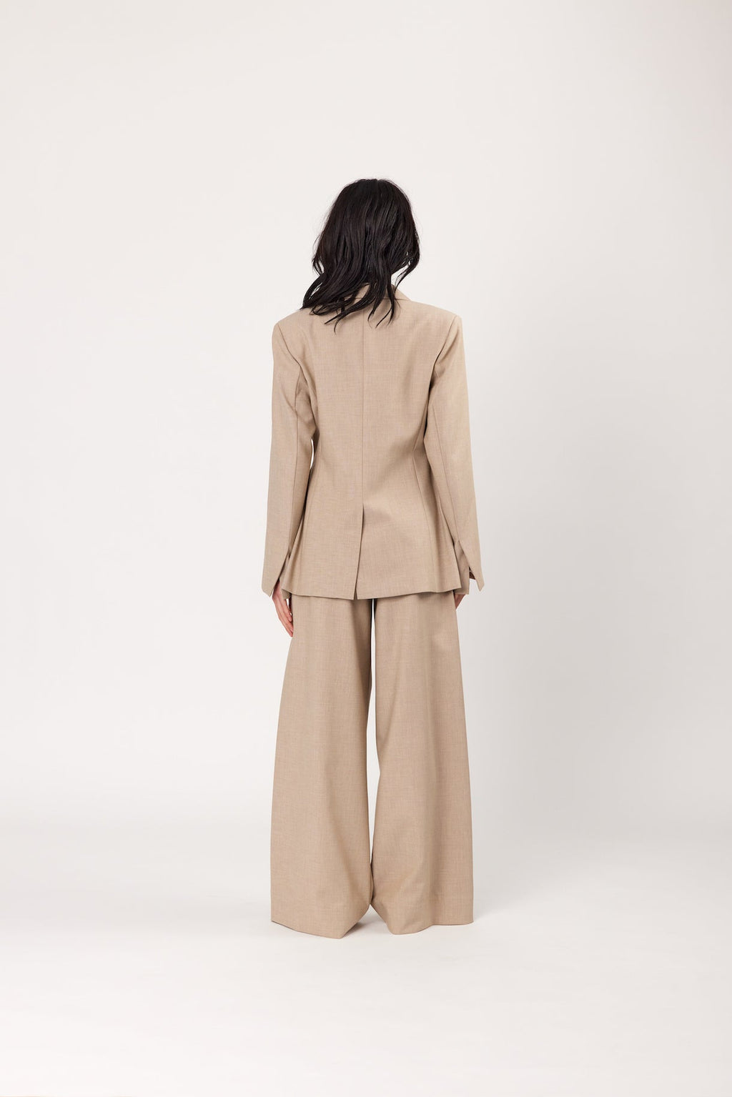 Oat blazer back view with long sleeves and structured, tailored shoulders