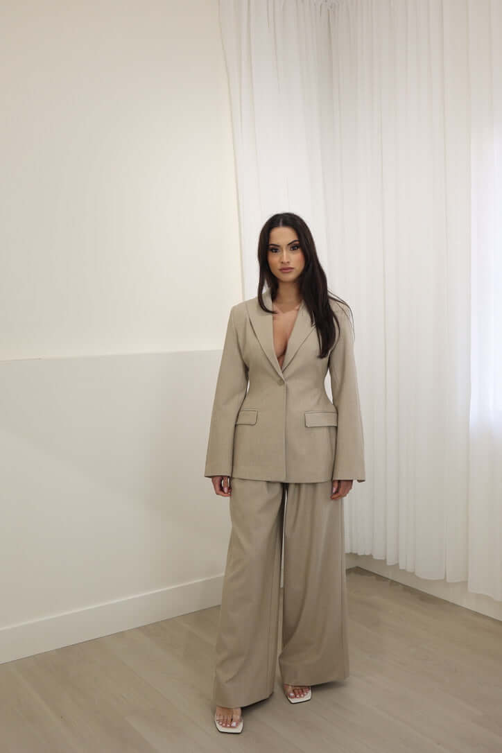 Oat blazer with notch lapels, single-button front, and flap pockets
