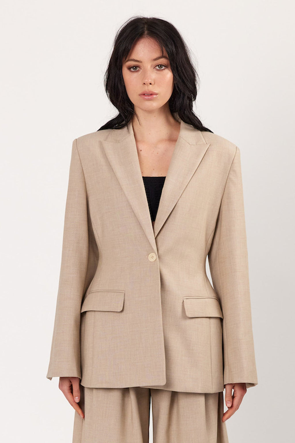 Oat blazer with notch lapels, single button, flap pockets, and long sleeves