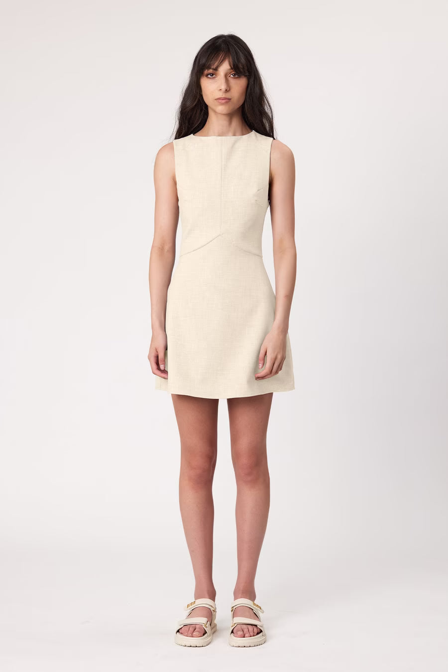 Bone sleeveless shift dress with rounded neckline and short hem