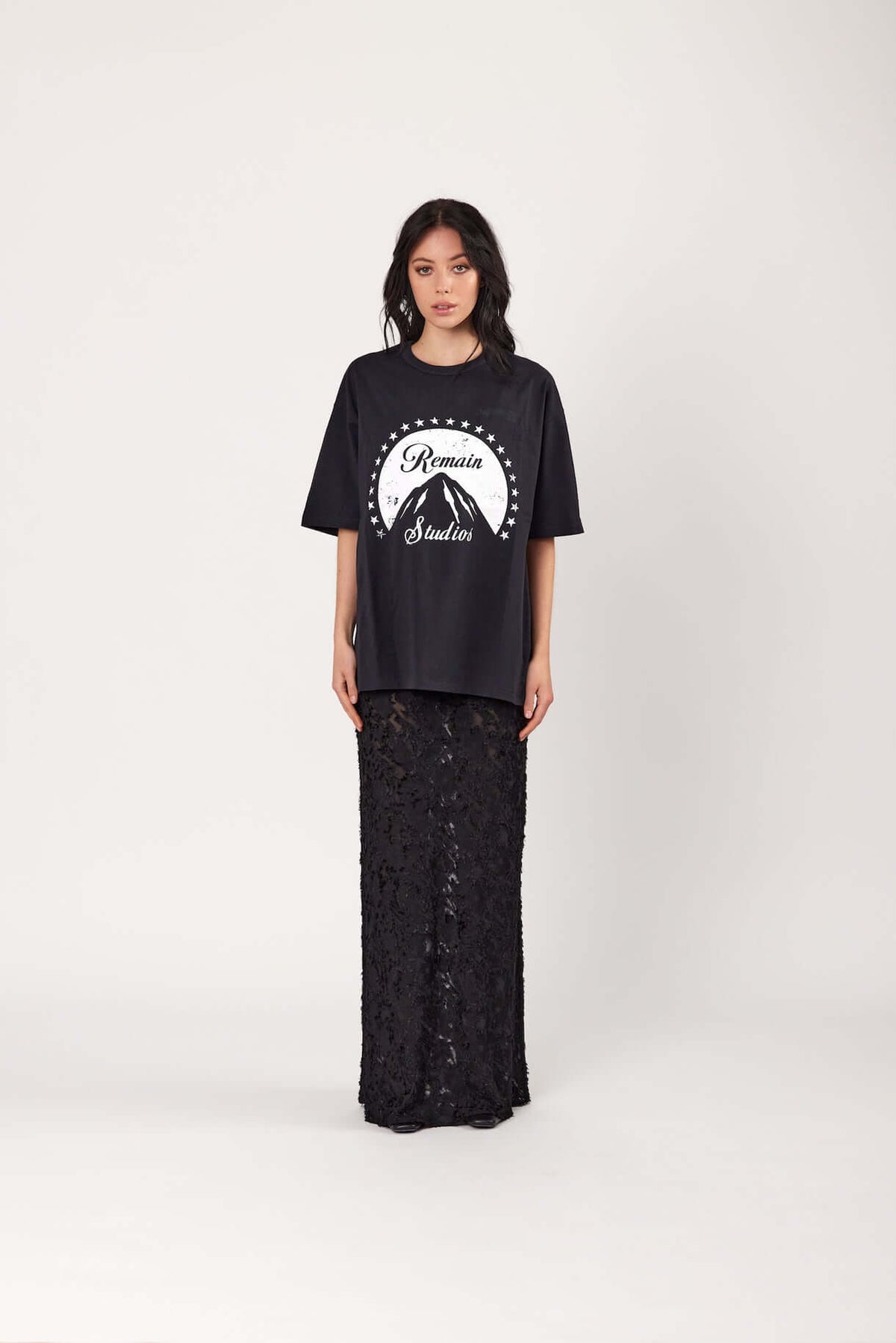 Black lace maxi slip dress with spaghetti straps, paired under a black graphic T-shirt