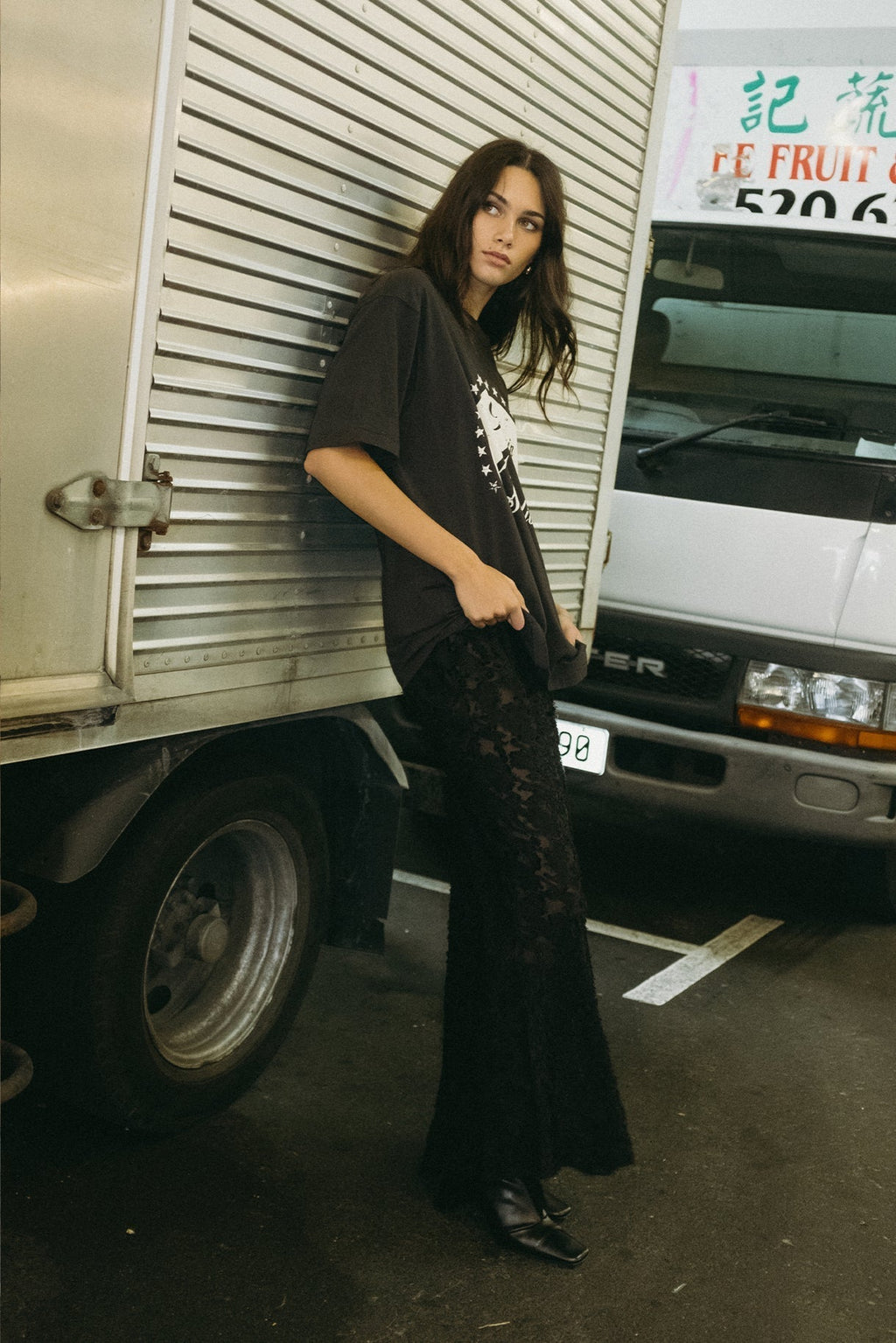 Black lace slip dress with thin spaghetti straps, maxi length, fitted bodycon shape