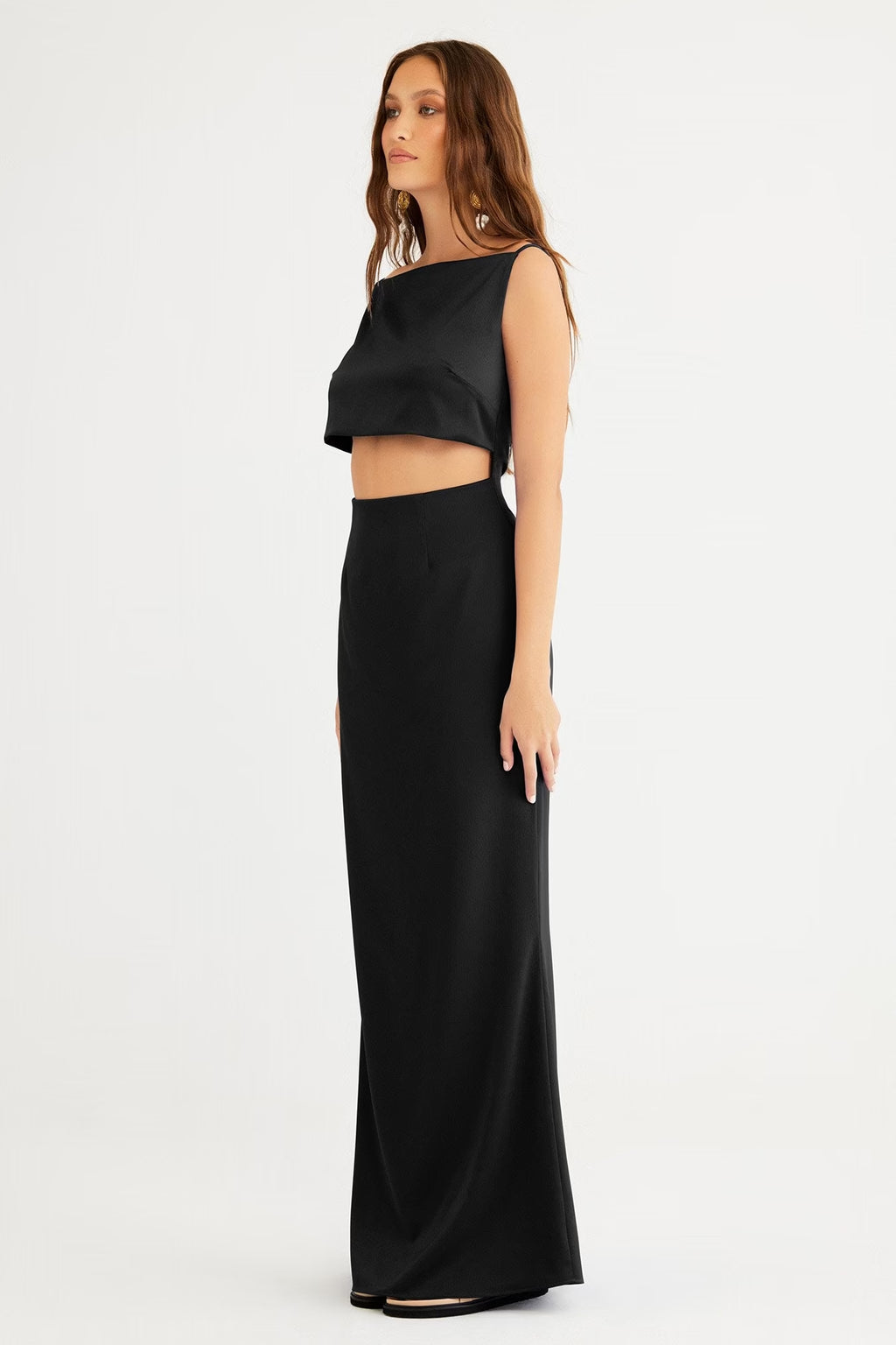 Black sleeveless crop-top gown with long column skirt, side profile