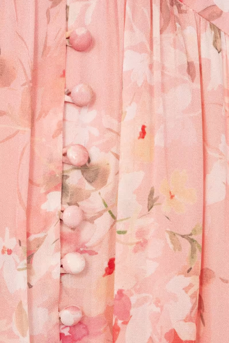 Pink sheer floral print fabric with soft drape and clustered texture along the surface