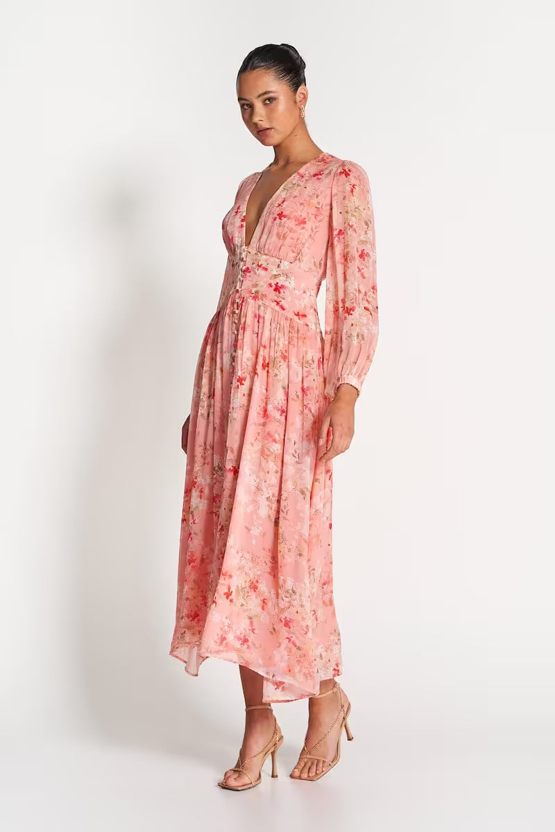 Pink sheer midi dress with floral print, long sleeves, and pleated tiered skirt