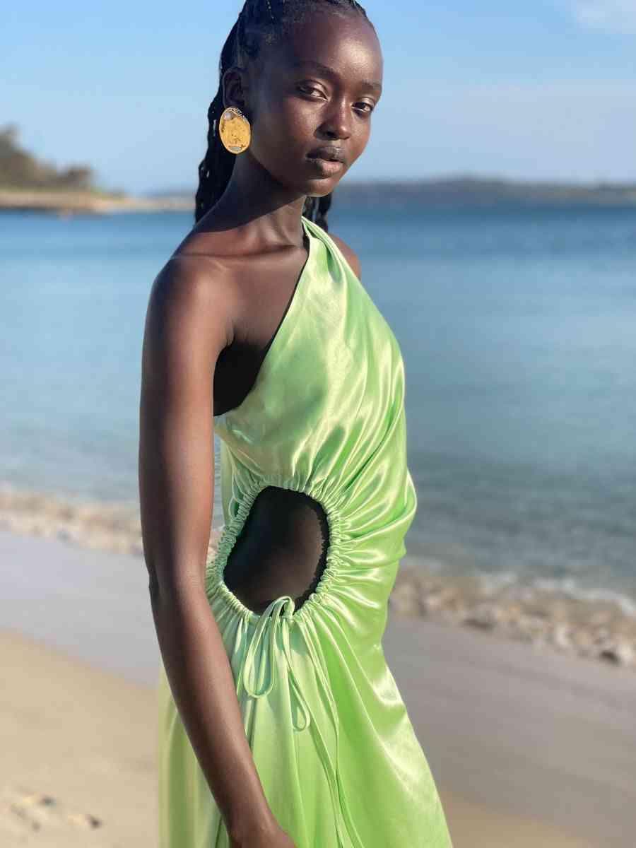 Light green halter maxi dress with side cutout, ruched bodice, and drawn waist ties.