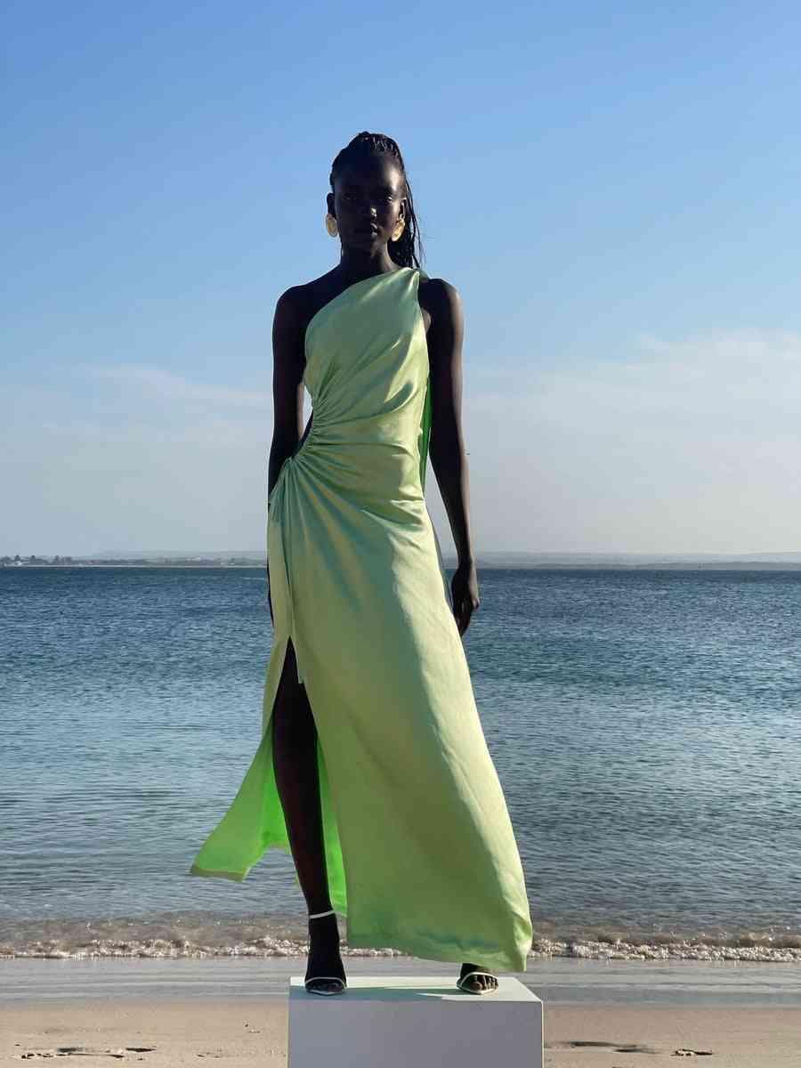 Light green satin halter maxi dress with ruched side drape and high front slit.