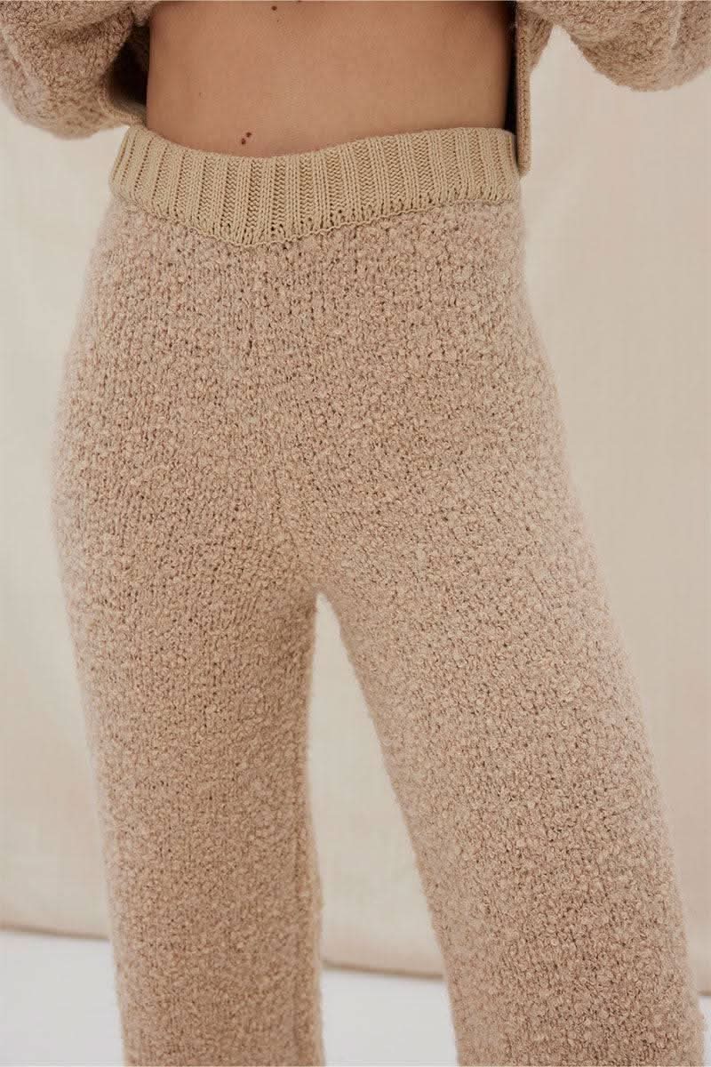 Mink knit pants close-up: textured fabric and ribbed waistband