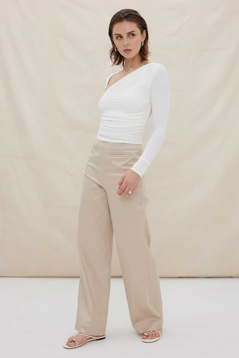White one-shoulder ruched long-sleeve top with fitted, draped waist