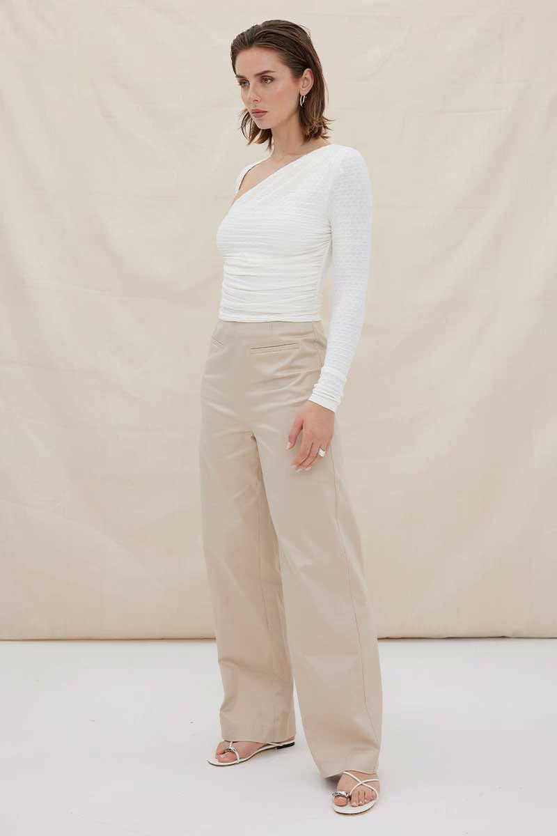 White one-shoulder ruched long-sleeve top with draped neckline and waist