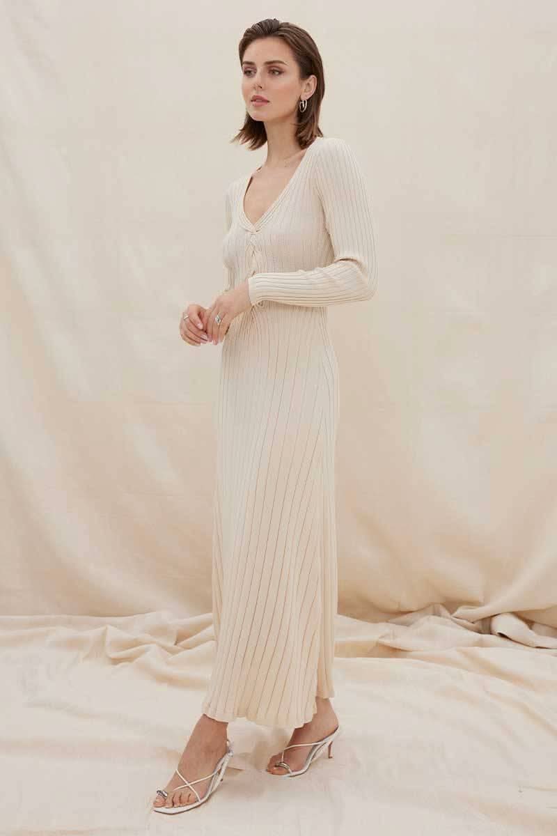 Natural ribbed long-sleeve midi dress with V-neck and lace-up front, standing pose