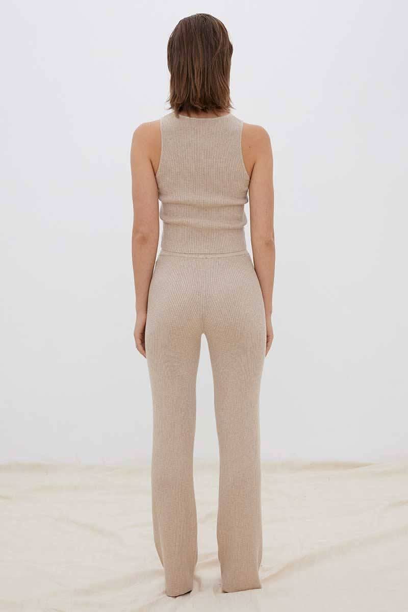 Back view of fawn knit pants with slim fit and straight-to-flare leg