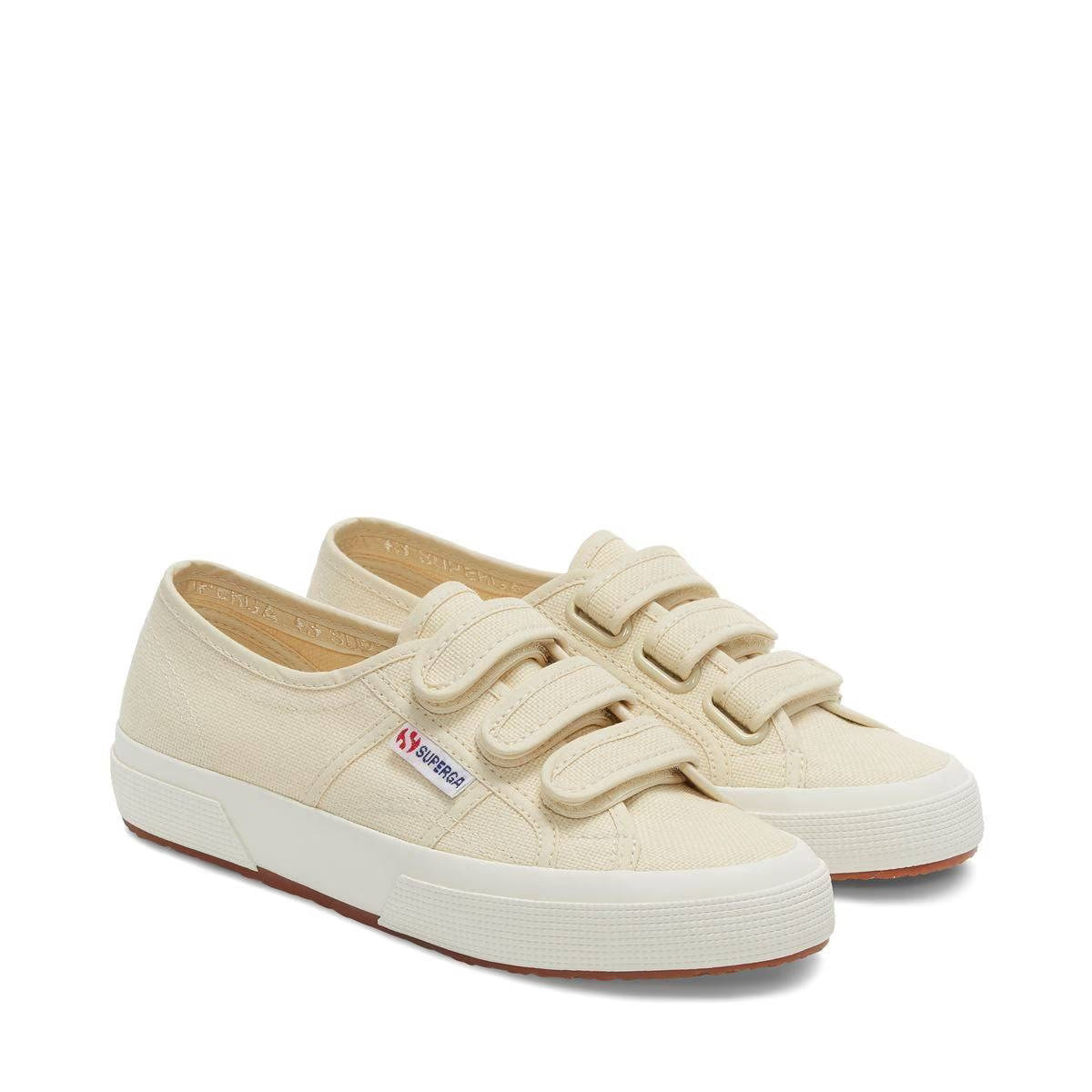 Light beige canvas sneakers, lace-up style with white rubber sole, side view