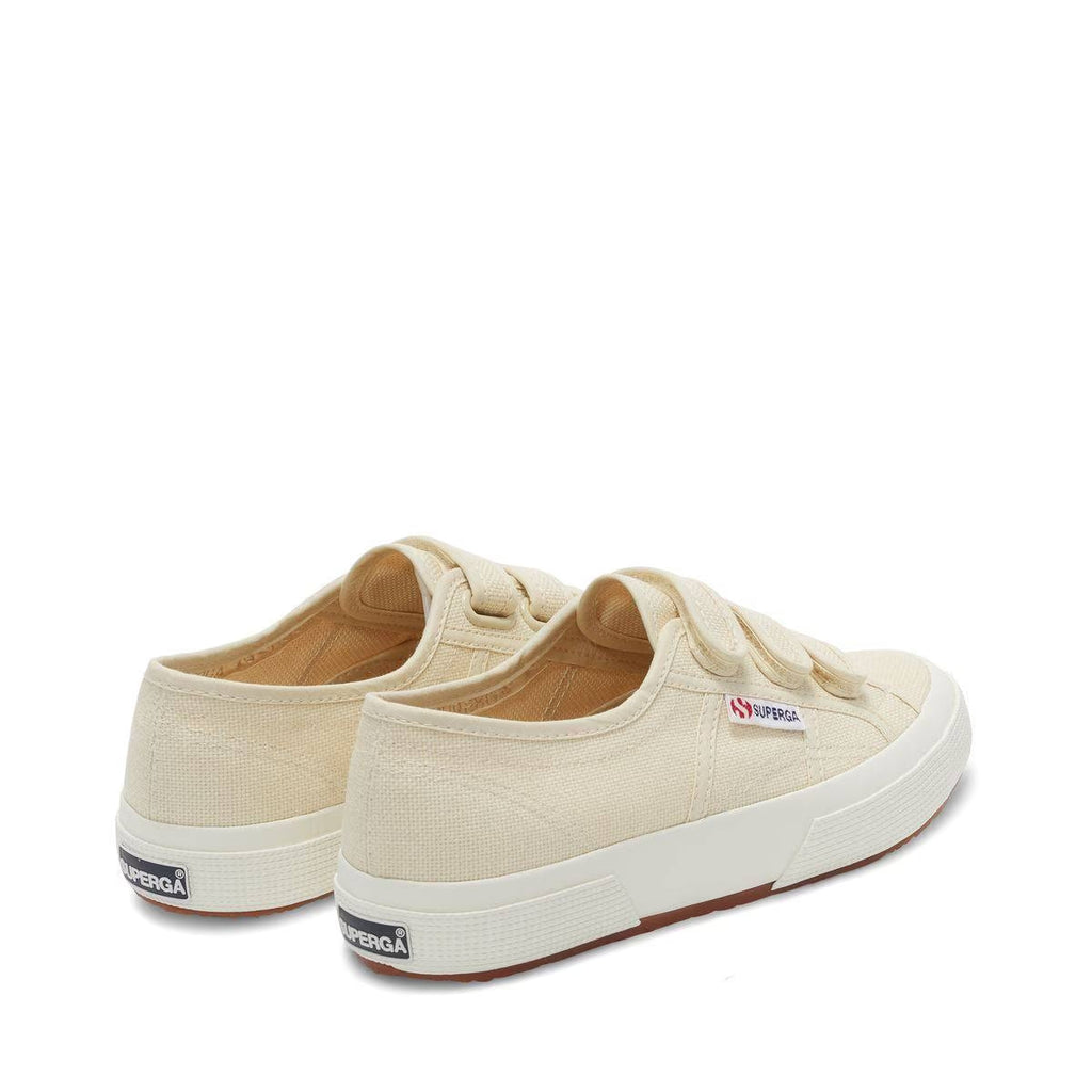 Light beige canvas sneakers with heel tab and white rubber sole, rear angle