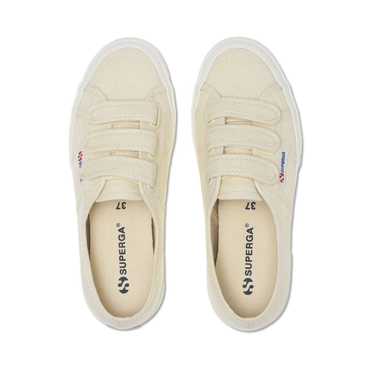 Pair of light beige canvas sneakers, front view with lace-up and Superga logo