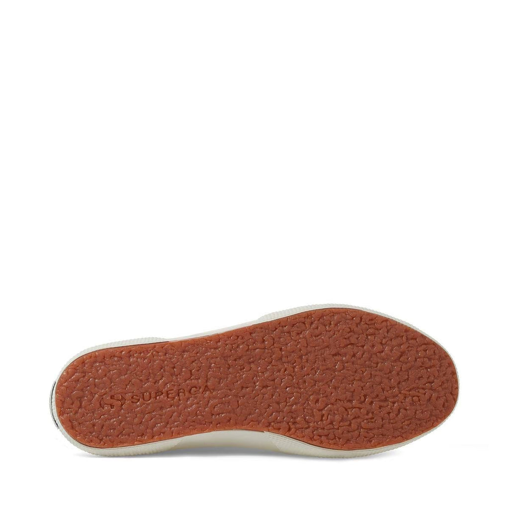 Light beige sneaker outsole with textured brown tread and white edge