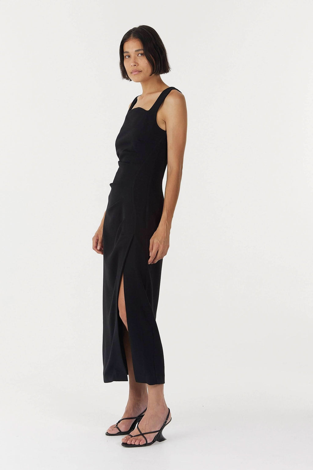 Black sleeveless square-neck midi dress with side slit and tailored fit
