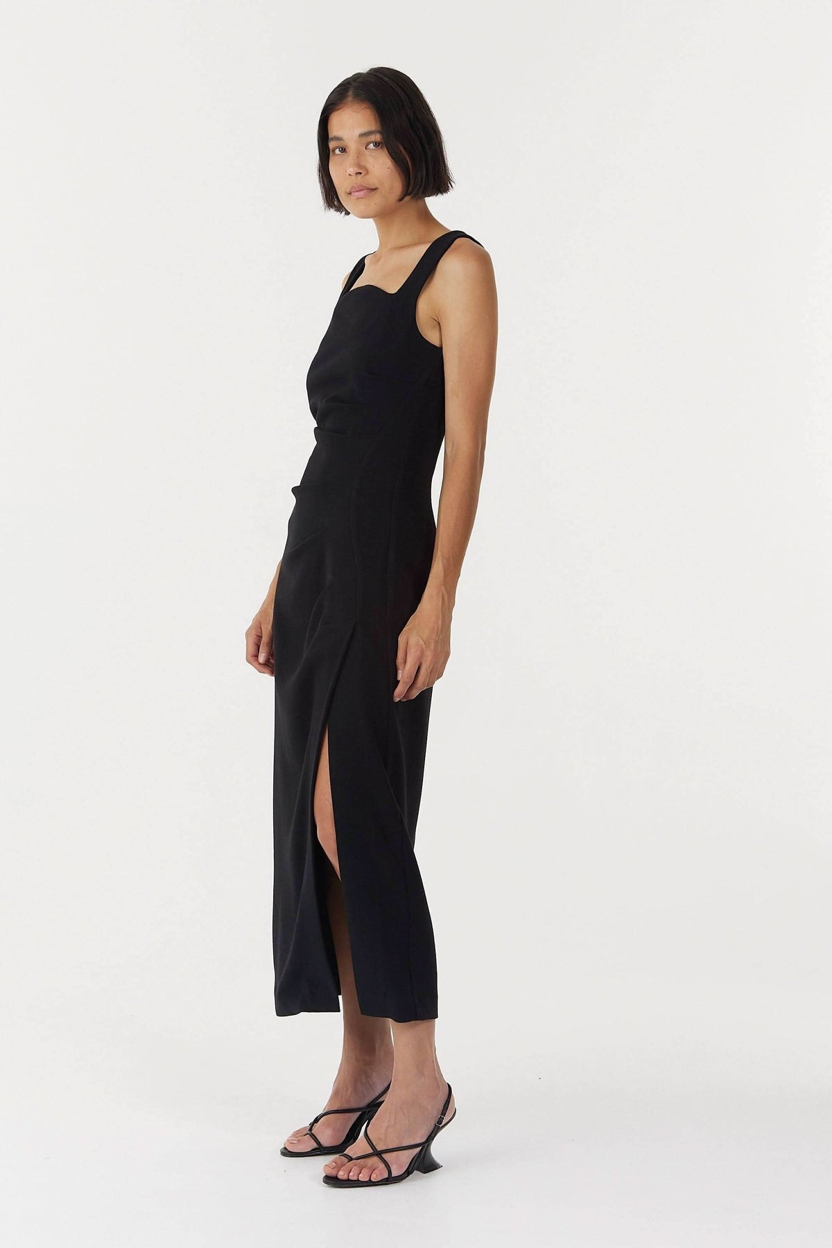Black sleeveless square-neck midi dress with side slit and tailored fit