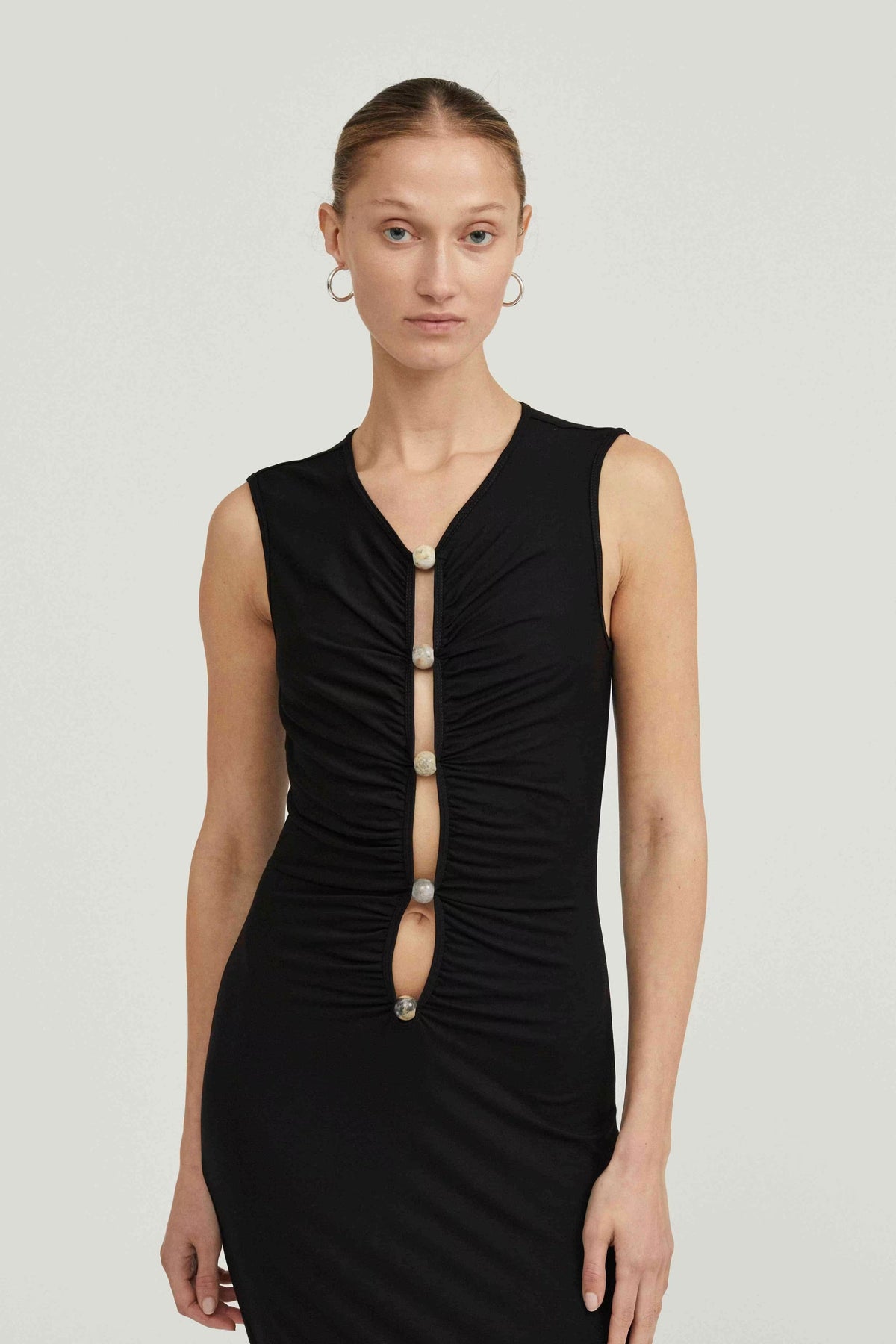 Black sleeveless maxi dress with V-neck and vertical ruched placket with buttons