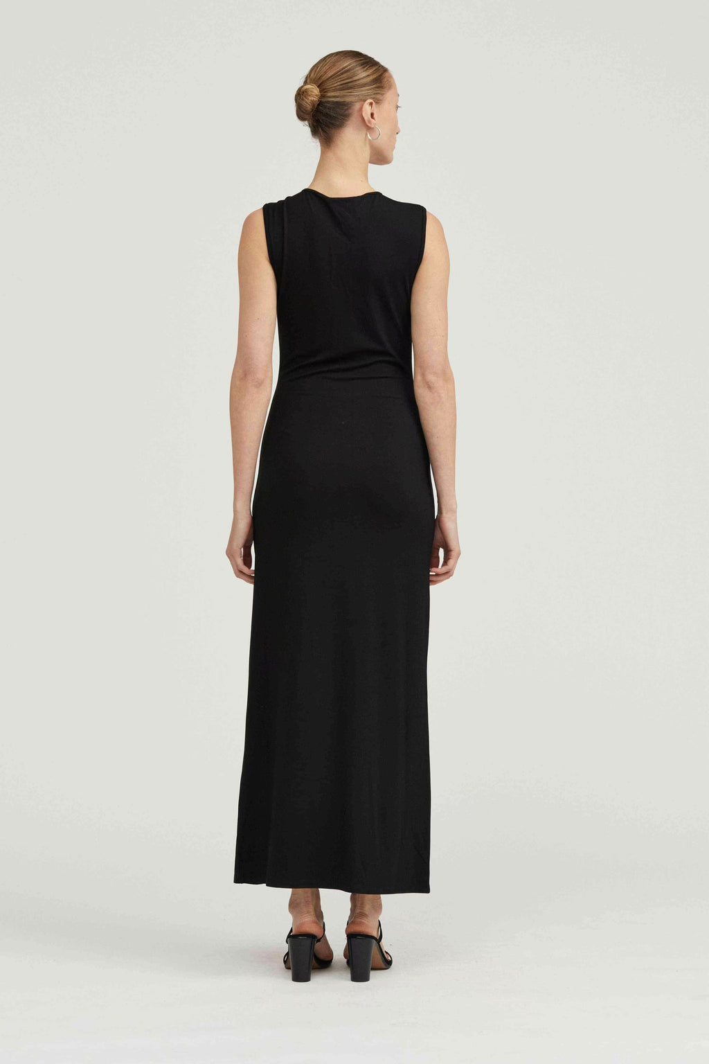 Black sleeveless maxi dress back view with simple shoulders and subtle side ruching